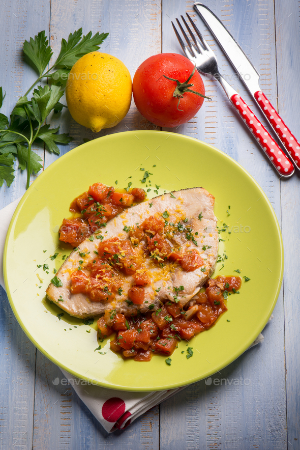 swordfish with fresh tomatoes and grated lemon peel Stock Photo by